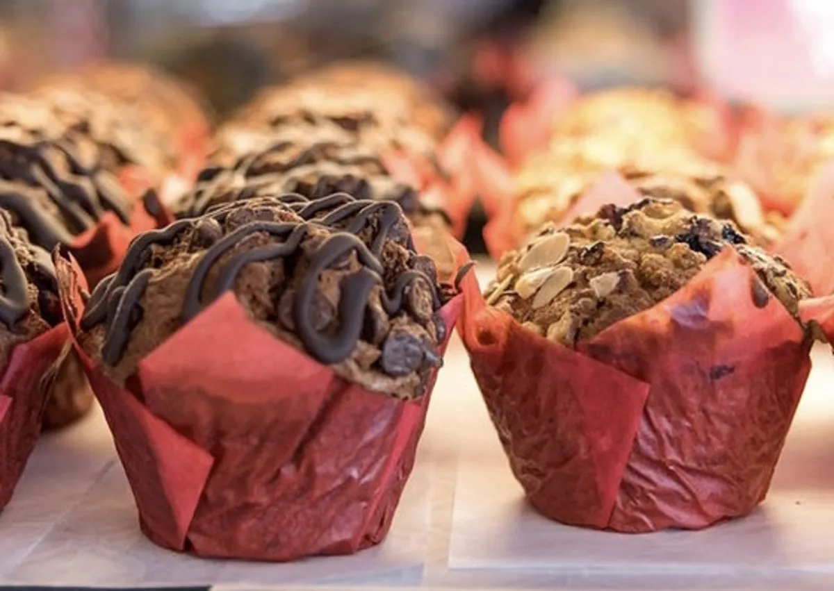 Chocolate drizzled muffins in red wrappers