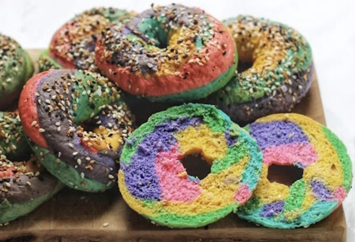 Colorful rainbow bagels with everything seasoning